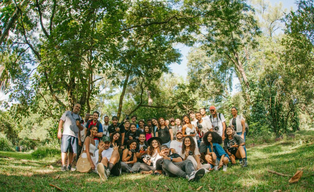 pexels-photo-16118486-16118486 A diverse group of joyful people posing together outdoors in a sunny park setting.
